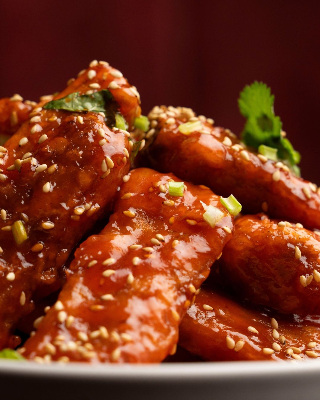 Sticky, glossy, sesame-topped